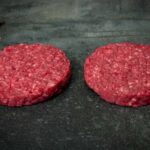 Rohe Creekstone Farms Burger Patties auf einer schwarzen Schieferplatte für Gezer Gastronomie-Kunden.