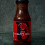 Eckart Scharfe Grillsauce No. 5 (250ml), pikant präsentiert auf einer Schieferplatte für Gezer Gastro-Kunden.