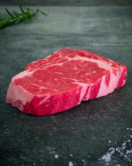 Rohes Ribeye Steak der Färse aus Pommern auf schwarzer Schieferplatte von Gezer Fleischmanufaktur GmbH.