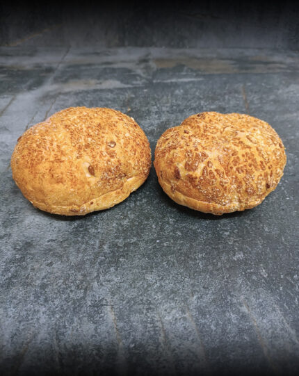 SweetGold Süßkartoffel Burger Buns, goldgelb glänzend auf einer Schieferplatte präsentiert für Gezer Kunden.