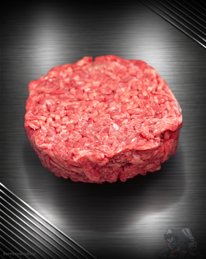 Rohes Haché Schweine-Burger Pattie aus grob gehacktem Schweinefleisch mit sichtbarer Struktur auf neutralem Untergrund.